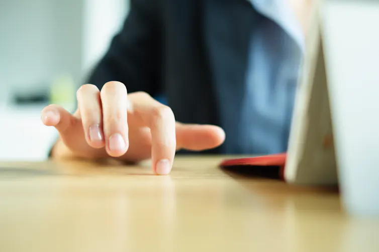 Fingers drumming on a desk