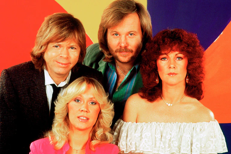 ABBA in front of colourful background