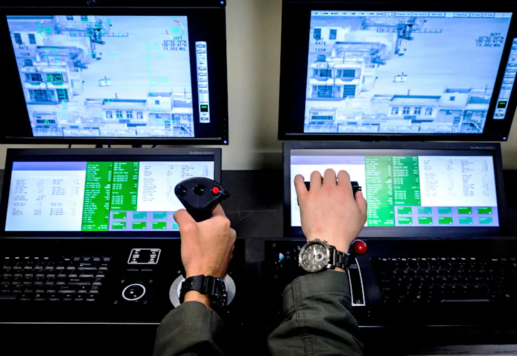 Hands of student pilots shown operating a joystick device to control a drone, with controls shown on a screen