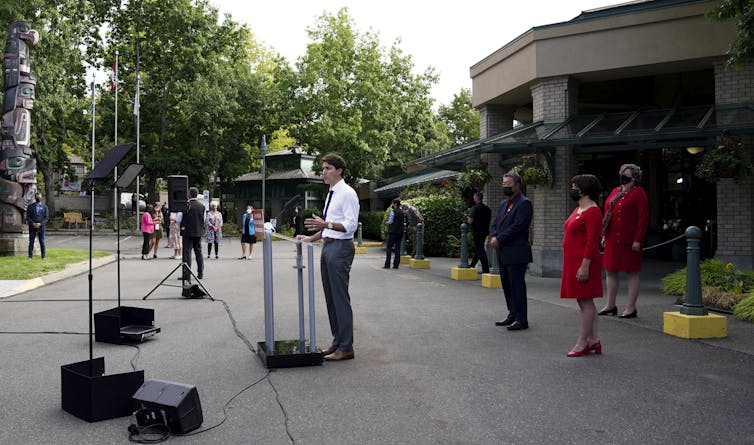 Liberal leader Justin Trudeau stands at the microphone outside a building