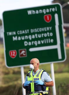 Police guard a COVID-19 testing checkpoint