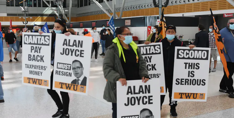 Unionists demonstrate against Qantas' staff cuts at Sydney's domestic terminal on August 27, 2020.