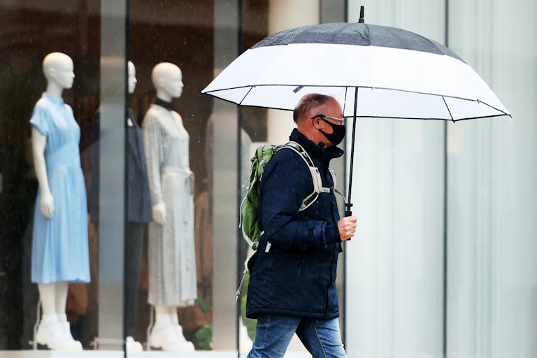 Man walking in rain