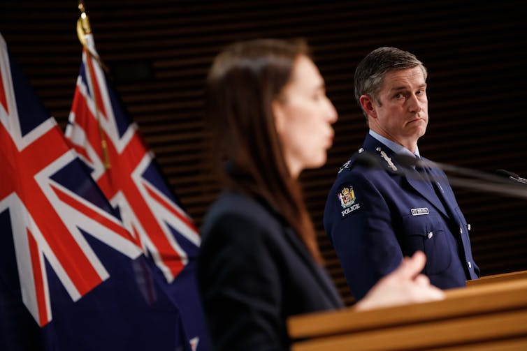 Police Commissioner Andrew Coster and Prime Minister Jacinda Ardern at lecterns