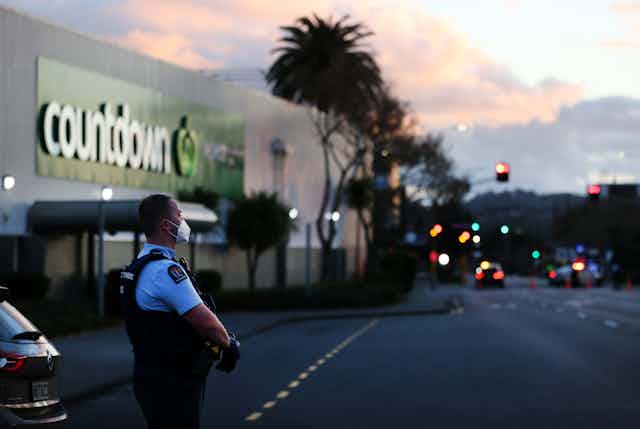 armed police officer outside supermarket