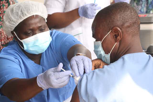 A person receives a dose of the Oxford/AstraZeneca coronavirus disease (COVID-19) vaccine at the Cacovid isolation centre, Mainland, Infectious disease hospital, Yaba, in Lagos, Nigeria.