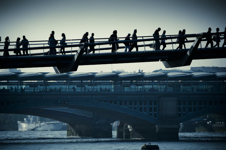 Commuters on a bridge in London.
