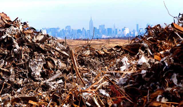 Manhattan skyline seen across piles of debris from the World Trade Center at Fresh Kills landfil.