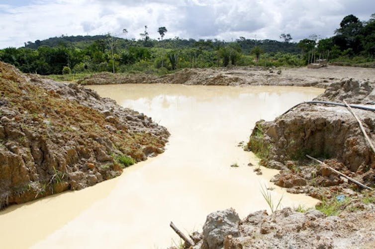 A river surrounded by deforested banks