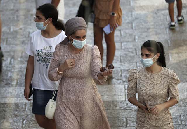 Israeli women in masks walking outside