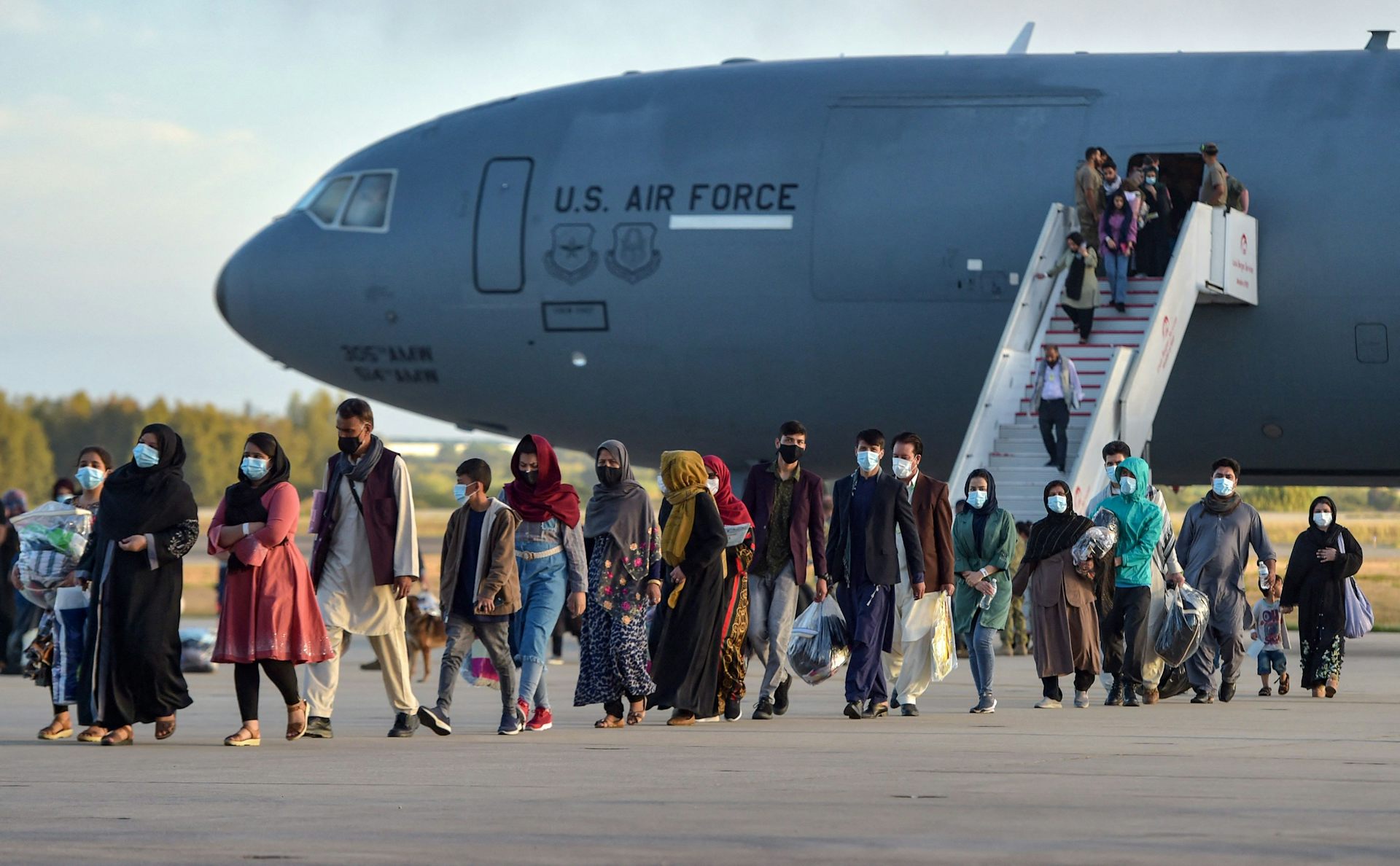 Afghan nationals disembark from a US air force aircraft after an evacuation flight from Kabul