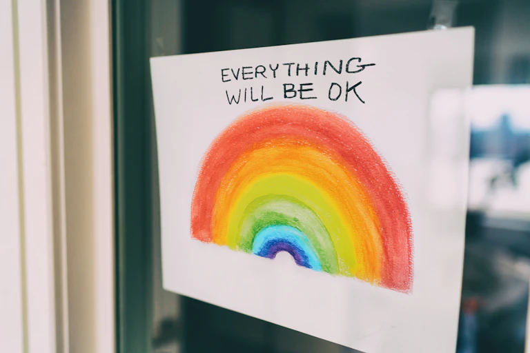Rainbow sign in window saying 'everything will be ok'