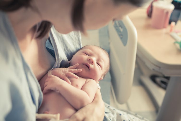 Newborn baby in mothers arms