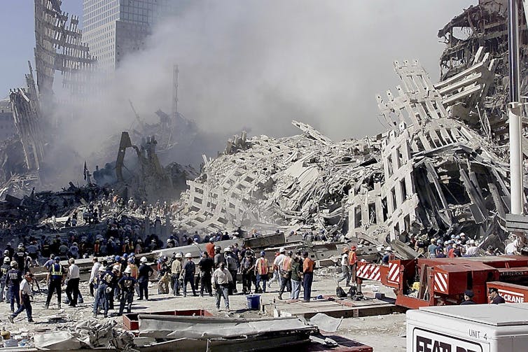 Fire and rescue workers search through the rubble of the World Trade Centrr