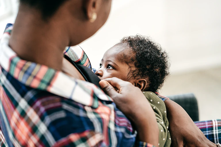 Mother breastfeeds baby
