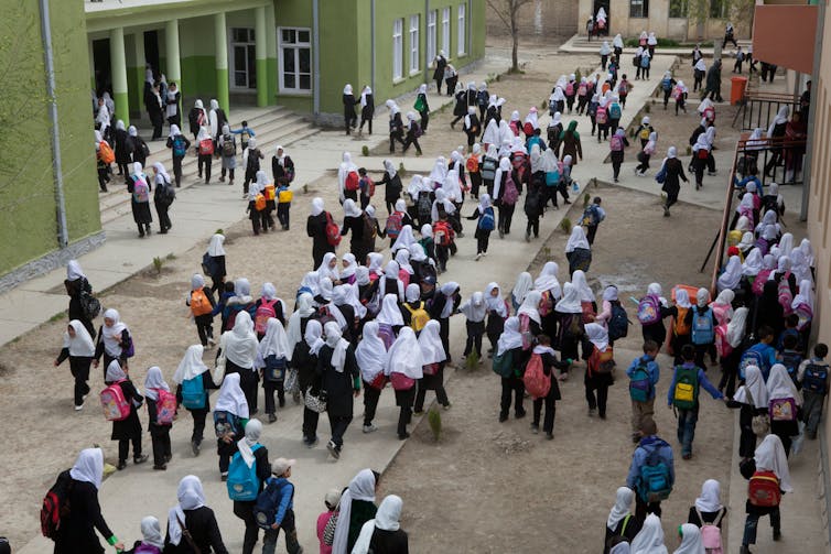 Schoolchildren head into class in a girls' school in Kabul