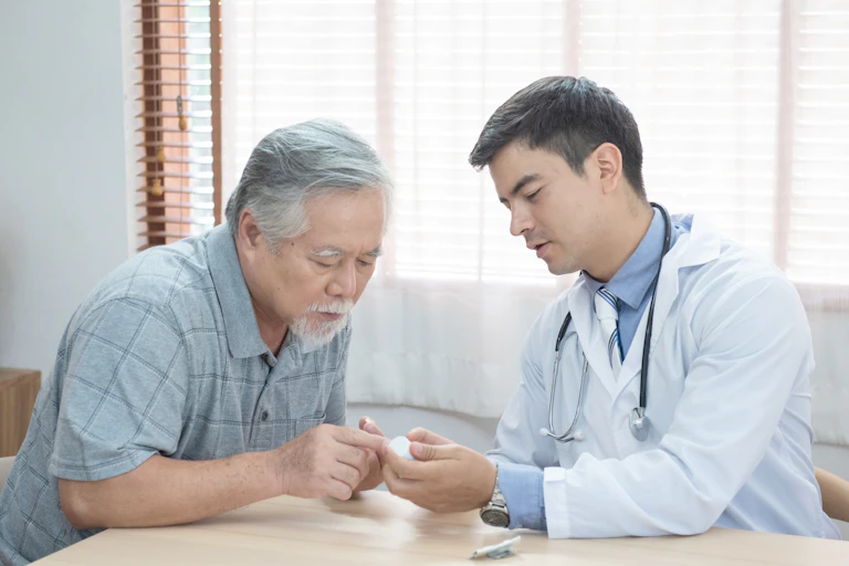 An older man speaking with his doctor about a prescription.