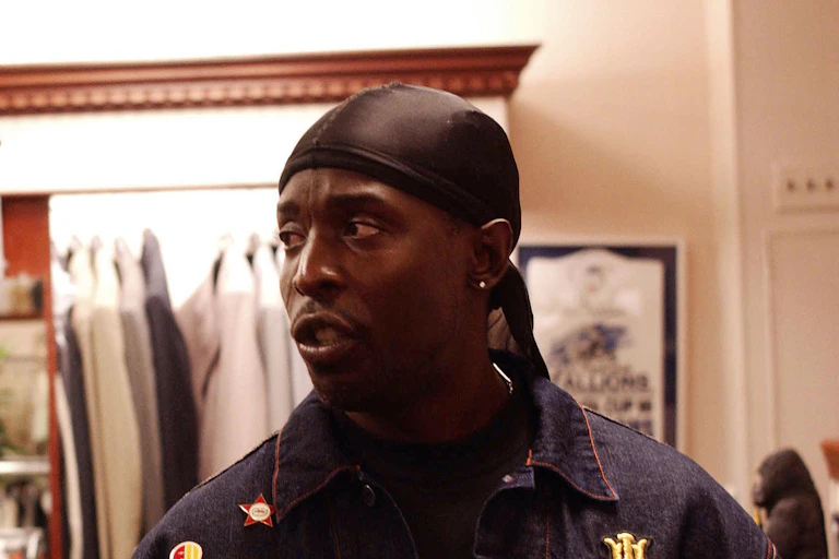 a man in a do-rag and denim jacket.