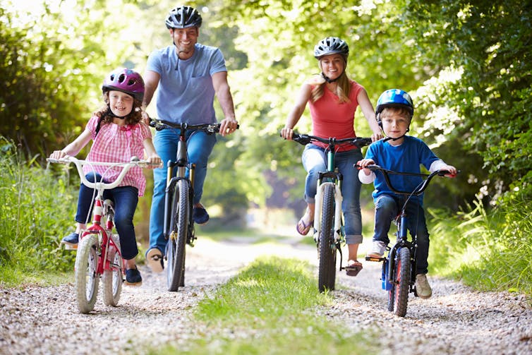 A family cycling in a park.