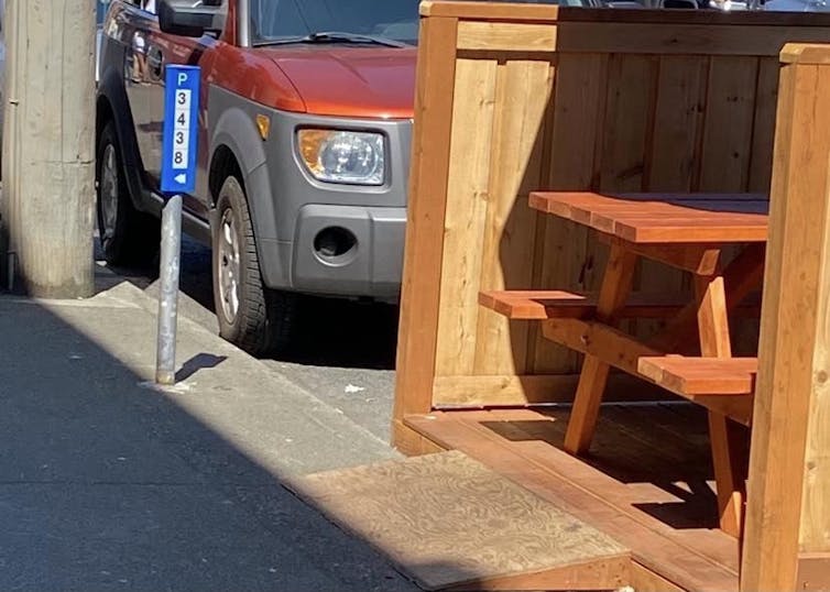 Image shows a tiny ramp leading up towards a picnic table