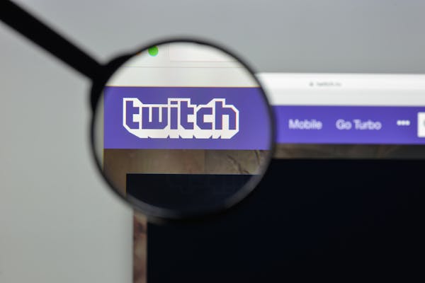 A magnifying glass is overtop of the twitch logo on a browser