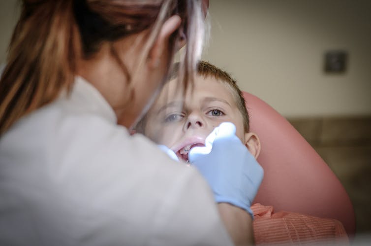 A woman dentist and a child patient