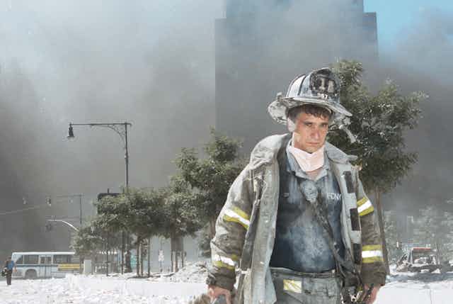 A New York City firefighter walks away from Ground Zero on 9/11