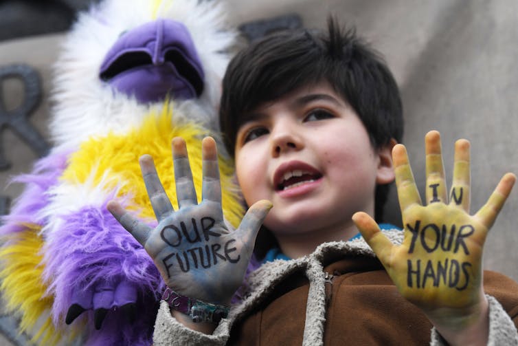 Boy with painted hands