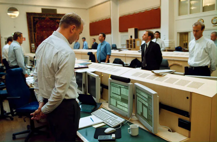 Traders standing for a minute's silence the day after the attack.