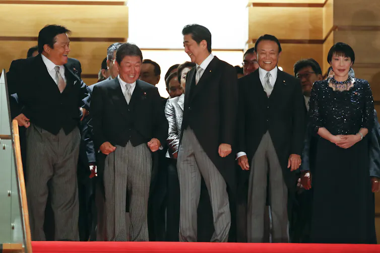 Shinzo Abe, then the Japanese prime minister, with his cabinet including communications minister Takaichi Sanae.