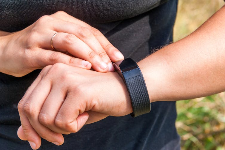 woman checks smart watch