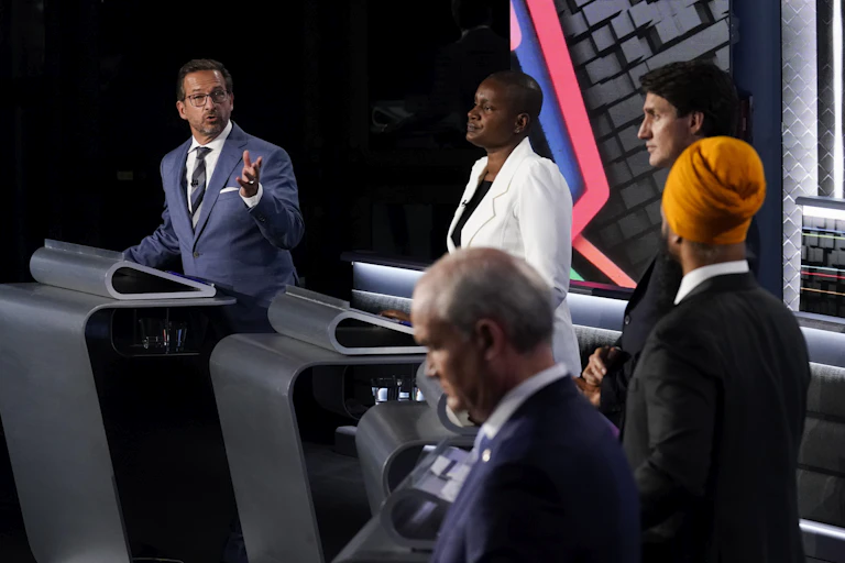 Five party leaders on a stage.
