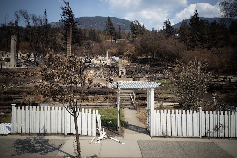 A white picket fence is all that remains after a fire tore through a property