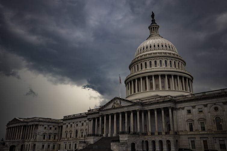 The U.S. Capitol, against a stormy sky background.