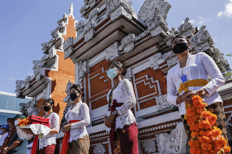 Balinese wait for passengers disembark from aircraft as Bali's tourism reopen for domestic visitors.