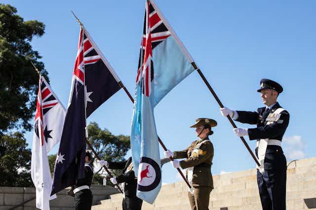 Flag bearers line up at an Anzac Day ceremony at the Shrine of Remembrance in Melbourne