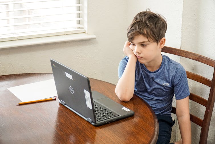 boy bored on laptop