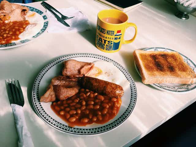A full English breakfast on a white table