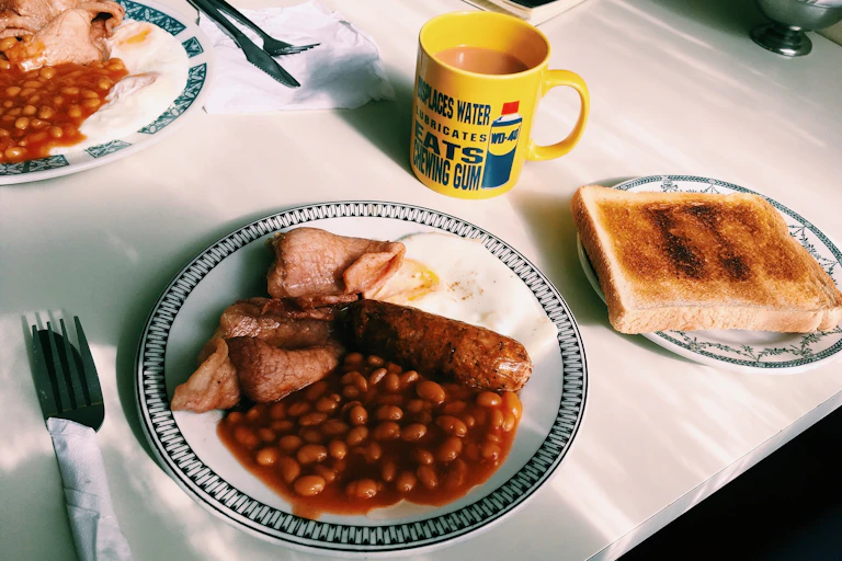 A full English breakfast on a white table