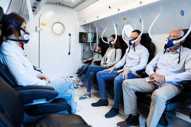 People wearing masks while having oxygen therapy in hyperbaric chamber.