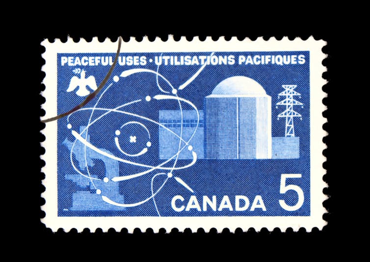 A blue and white stamp that reads PEACEFUL USES UTILISATIONS PACIFIQUES