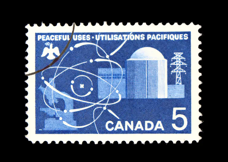 A blue and white stamp that reads PEACEFUL USES UTILISATIONS PACIFIQUES