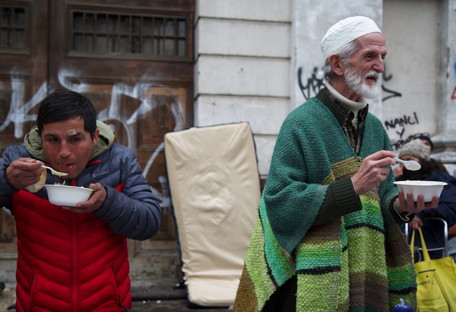 Chilean Muslims and people from other religious communities eat a meal at the weekly soup kitchen in Santiago, Chile.