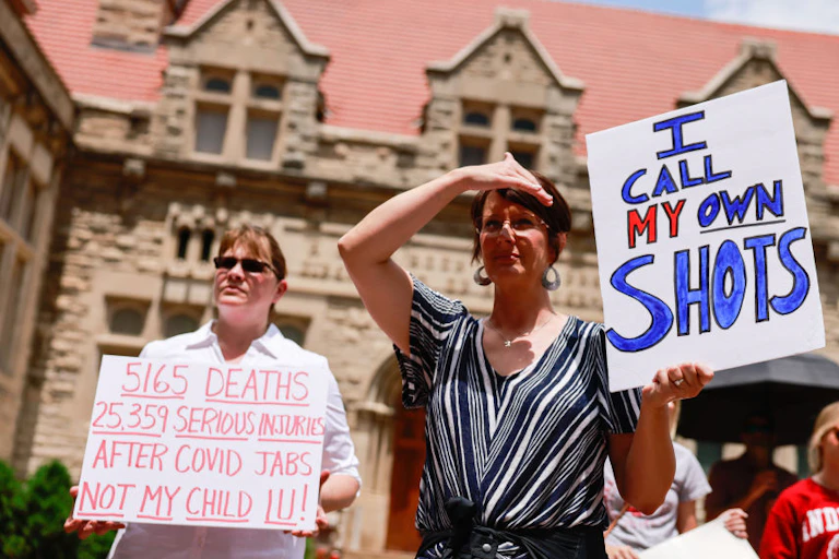 Anti-vaccination protesters hold placards at Indiana University in June 2021rsit