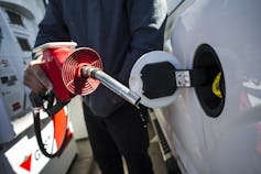 A person fills up a truck with gas.