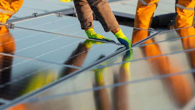People installing solar panels