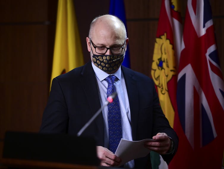 David Lametti wearing a face mask standing at a podium
