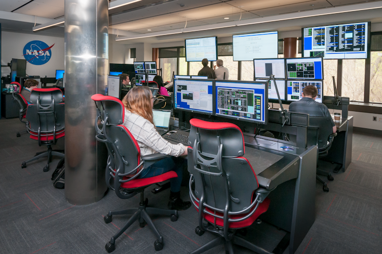 People sitting at desks using computers.