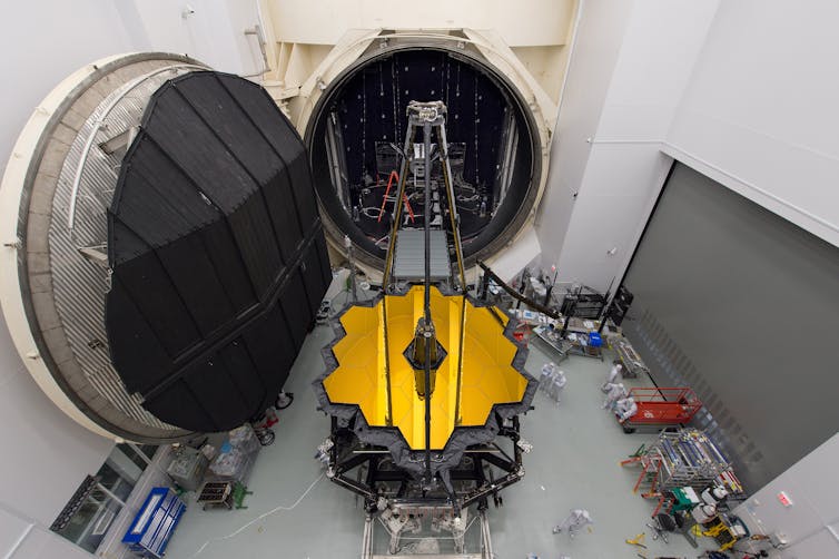 The assembled telescope being wheeled out of a large chamber.