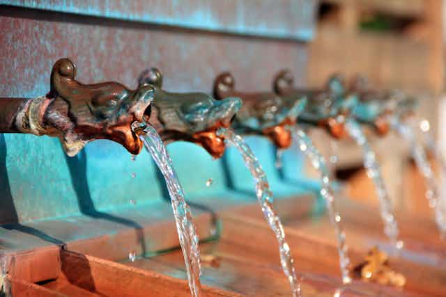 A series of taps with water flowing from them